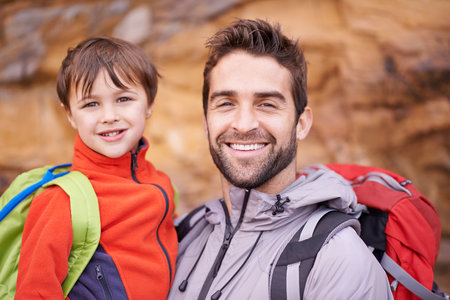 Hes a keen little hiker. a father and son enjoying a hike together.の写真素材
