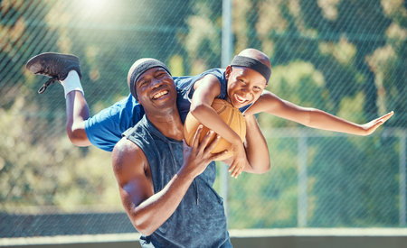 Basketball court, father and child smile together with playful and funny moment in game together. Happy, fun and healthy black family have outdoor bonding time in sports exercise break.の写真素材