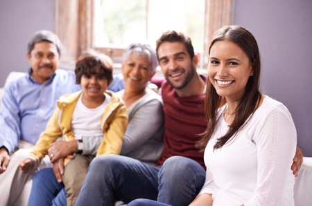 Together forever. Portrait of a family bonding together in the living room.の写真素材