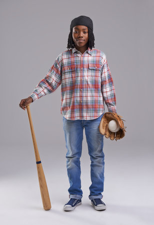 Ready for baseball. Studio shot of a young boy with baseball gear.の写真素材