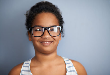 Smart girls wear their glasses. a young girl wearing glasses.の写真素材