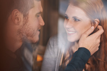 Bewitched by her beauty. A cropped shot of a young couple being affectionate.の写真素材