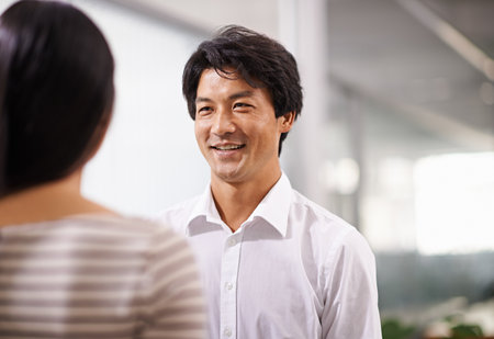 Only good vibes in this office. two business professionals having a discussion in an office.の写真素材