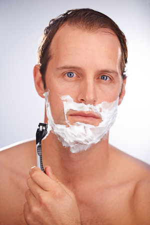 That was a close shave. a man shaving isolated on white.の写真素材