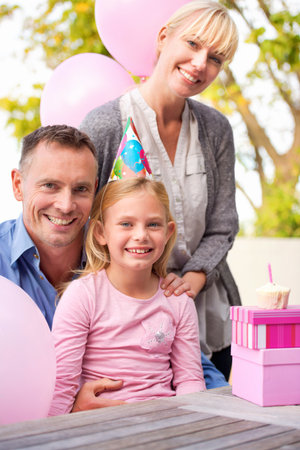 Happy family birthday moments. A cropped portrait of a happy little girl and her parents celebrating...