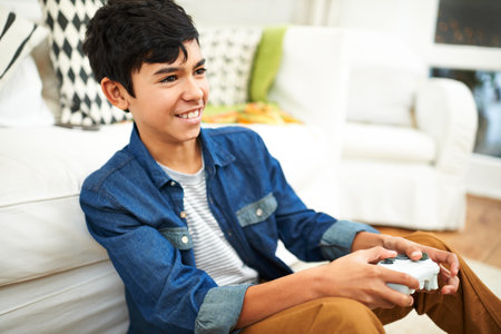 Im gonna win. a young ethnic boy playing video games.