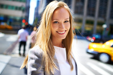 City slicking it today. A cropped shot of a beautiful woman walking around the city in the day time.