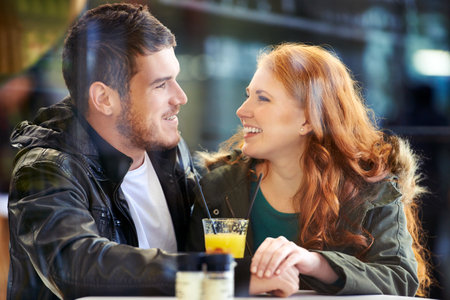 In a world of their own. a happy young couple on a date at a cafe.の写真素材