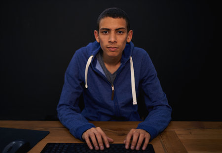 Working on a new game. a young programmer focused on his work.