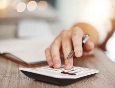 Calculator, budget and financial hands planning numbers, banking and trade cost, savings and company audit. Closeup man in asset management, accounting pay and investing taxes finance for bookkeepingの写真素材