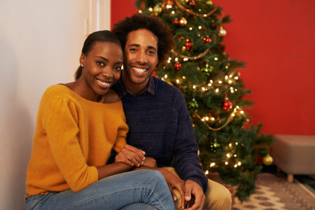 Its a time to be joyful. Portrait of an affectionate young couple on Christmas.の写真素材