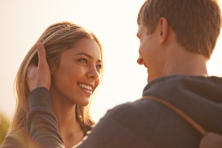 You make this moment perfect. an affectionate young couple sharing a moment outdoors.の写真素材