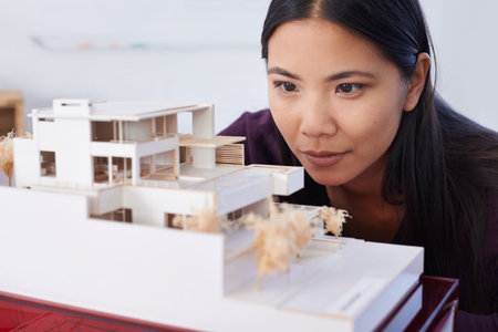 The product of patience and a lot of glue. Close-up of a young student viewing a scale model.