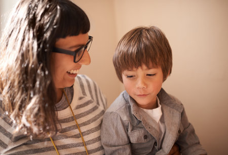 Theres nothing like a mothers love. A little boy sitting with his mother.