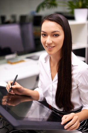 Technology always gets the job done quicker. Portrait of an attractive young businesswoman working...