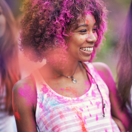 Filled with color. happy friends having fun with powder paint.