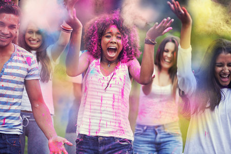Color me excited. Portrait of a group of friends having fun outdoors at a color festival.