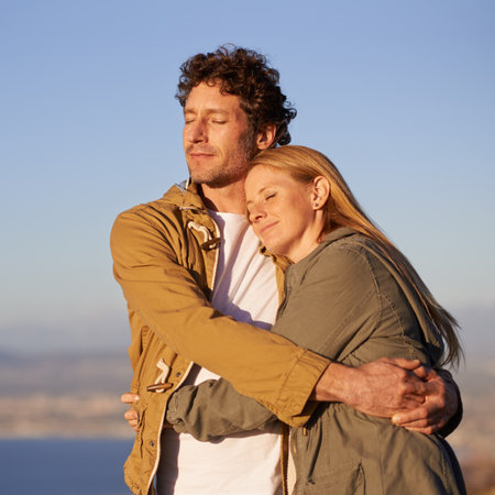 A cropped shot of a happy affectionate couple standing together outdoors.