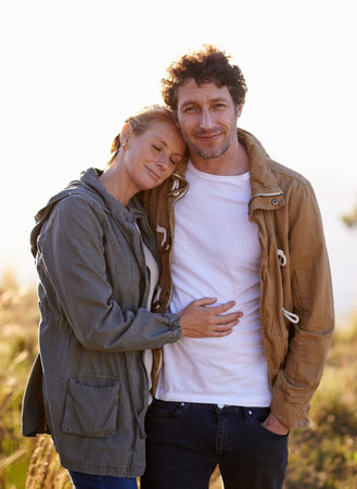 A romantic stroll outdoors. A cropped portrait of a happy man standing affectionately with his wife...