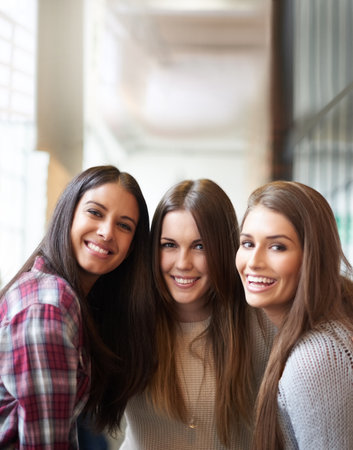 Portrait of three female university students on campus.の写真素材
