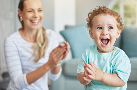 Happy, clapping hands and mother and son playing in the living room of their family home. Happiness,...