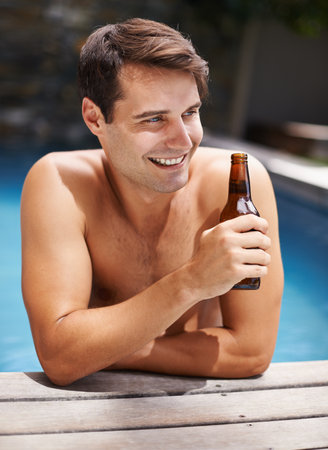 a young man standing in the pool.の写真素材