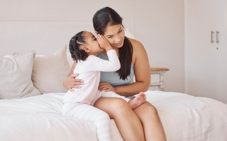 Kids whisper secret in mom ear in home bedroom for trust, love and confidential talk. Care mother...