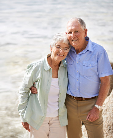 Together wherever life leads them. Portrait of an elderly couple on the beach.の写真素材