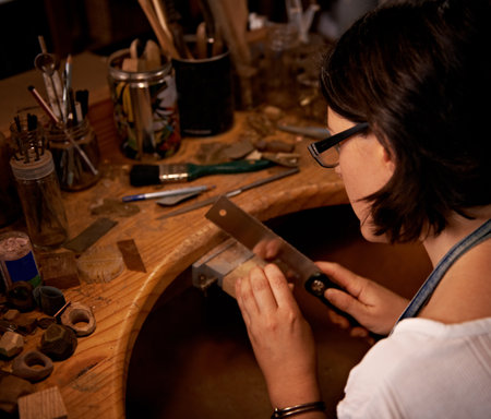 An artist creating something out of wood.