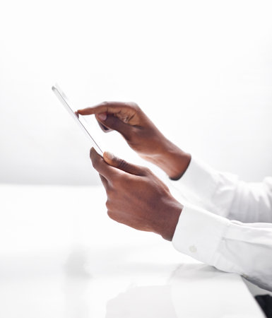 a man touching his digital tablet.