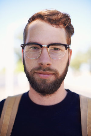The epitome of geek meets hip Meet the modern hipster. A handsome young hipster outdoors while...