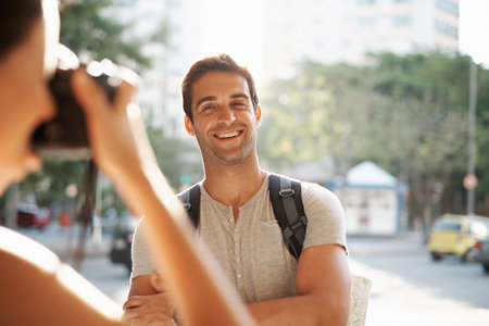 Thats one for the postcard. a young man posing for a photo while touring a foreign city.