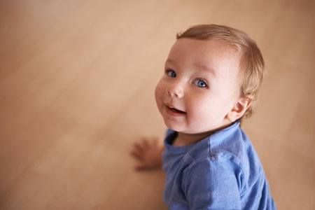 The cutest smile. An adorable infant looking up at the camera.の写真素材