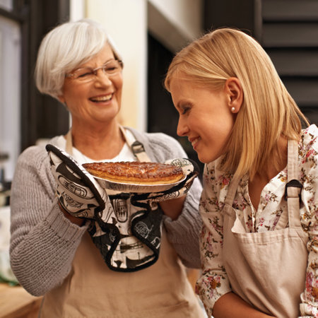 Smells like home. a young woman smelling the baked pie her grandmother made.