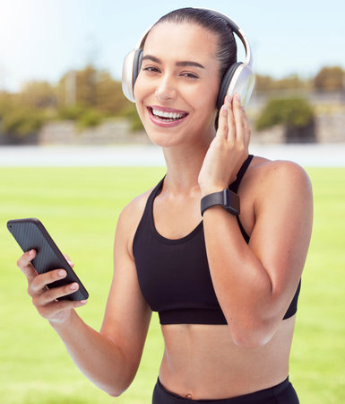 Headphones, fitness and smartphone with woman listening to motivation podcast or music outdoor on...