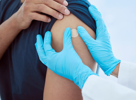 bandage, hands and vaccine injection for covid, flu or global virus in security, safety or wellness insurance hospital. Zoom on doctor, medical employee or healthcare worker with arm plaster for manの写真素材