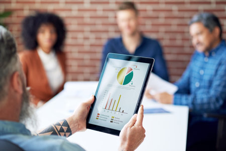 businessman using digital tablet computer presenting financial graph data on screen discussing...
