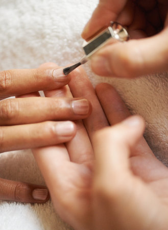 a woman getting her nails painted.の写真素材