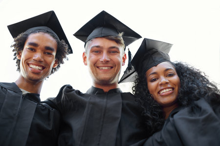 The big day is finally here. Portrait of happy college graduates in their gowns.