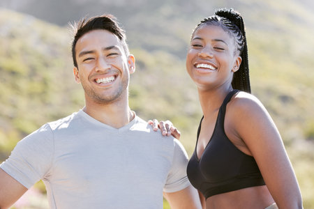 Fitness, nature and couple happy to workout in outdoor adventure trail. Sports, exercise and man and black woman train in sun together. Wellness, health and runner and personal trainer smile in park.の写真素材