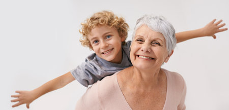 Look Gran, i can fly. a grandmother giving her grandson a piggback.