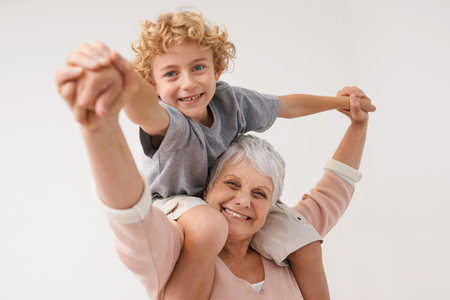 Having loads of fun with Granny. a grandmother giving her grandson a piggback.の写真素材