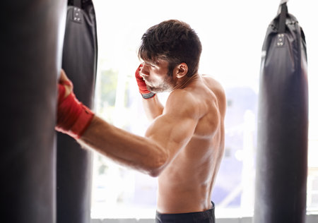 Kickboxing is his life. a handsome young kickboxer in the gym.の写真素材