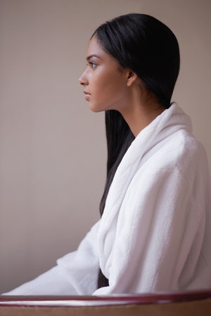 Ethnic Elegance. Side profile of a beautiful young woman wearing a bathrobe.の写真素材