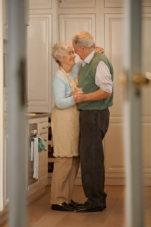 Care for a dance. Full-length shot of an elderly couple standing together in their home.の写真素材