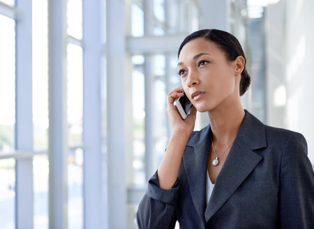 Shes always on call. An ethnic businesswoman talking on a cellphone.の写真素材