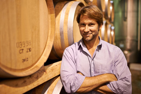 I built this estate from the ground up. a handsome mature man standing in a wine cellar.