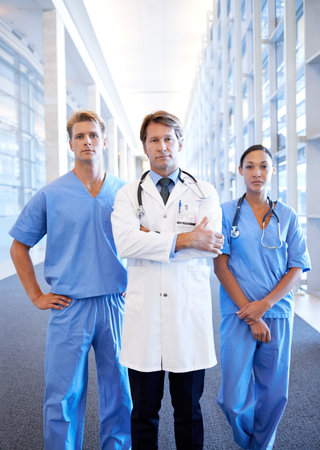 No doctor can do it on their own. A medical team standing in the hospital corridor.の写真素材