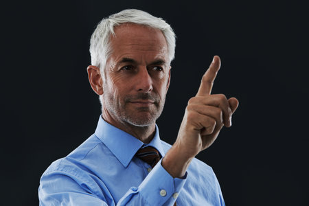 Using a digital interface. A handsome businessman using a digital interface.