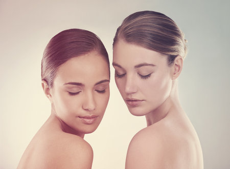 Lost in their own beauty. Studio beauty shot of a two young models.の写真素材